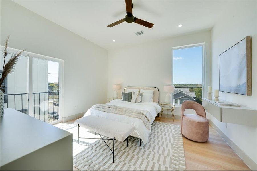 Bedroom featuring access to outside, multiple windows, light hardwood / wood-style floors, and ceiling fan