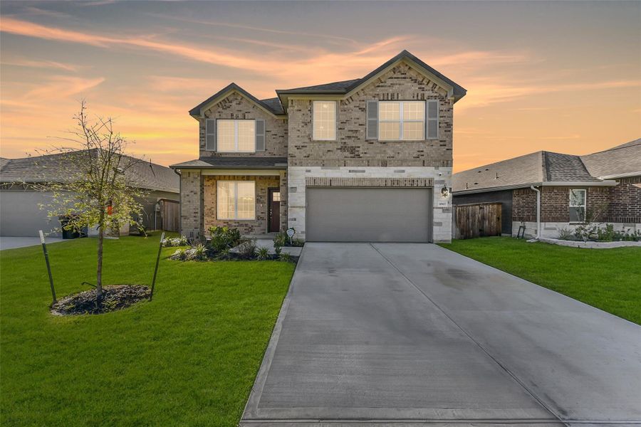 Front exterior of a new home in Sundance Cove - Premier Series, Crosby, TX, highlighting curb appeal (Image 1).