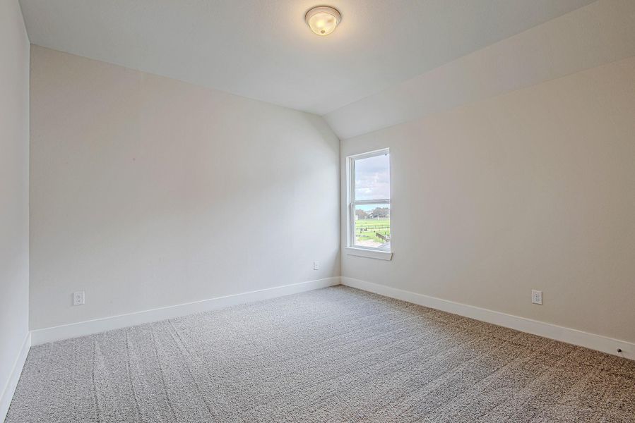 Bright secondary bedroom with inviting layout and plush carpet. Bright secondary bedroom with inviting layout and plush carpet.