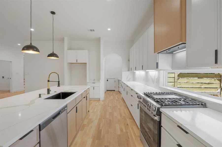 An elongated transom window fills the kitchen with an abundance of natural light while adding a distinctive architectural element to the space. This thoughtful design feature creates a bright, inviting atmosphere, making the kitchen as inspiring for the home chef as it is beautiful. An elongated transom window fills the kitchen with an abundance of natural light while adding a distinctive architectural element to the space. This thoughtful design feature creates a bright, inviting atmosphere, making the kitchen as inspiring for the home chef as it is beautiful.