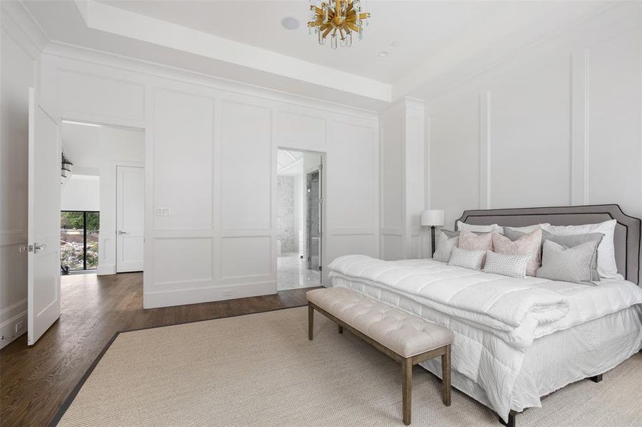 The whole of the third floor is dedicated to the expansive private primary suite (plus convenient laundry room and linen closet). Intricate details such as floor-to-ceiling trim detailing, oversize windows, and custom stained hardwoods create a luxurious and peaceful retreat. Image from previously completed home in the community.