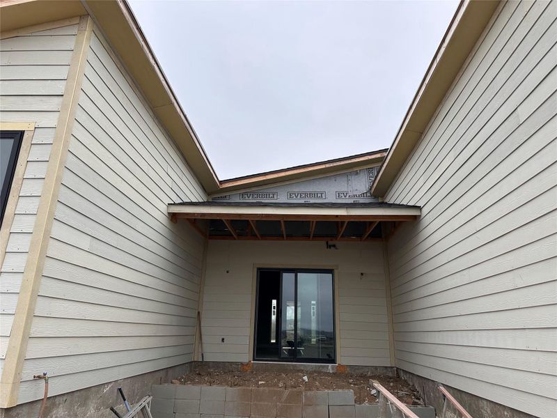 View of exterior entry featuring a patio area