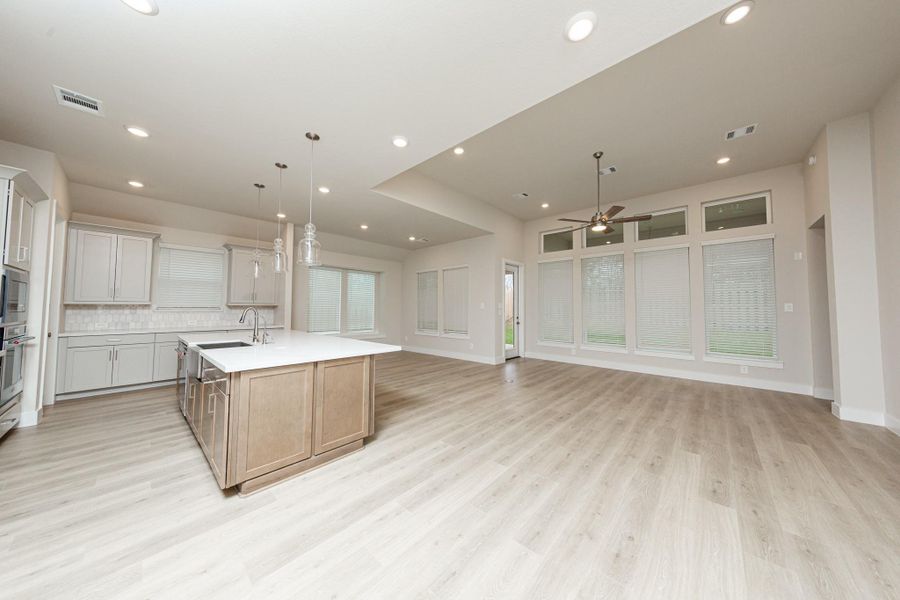 Enjoy a seamless flow between the living, dining and kitchen areas, perfect for entertaining. Access the tranquil outdoors through a modern, full-lite glass patio door which provides abundant natural light and an open view of the private fenced backyard. Enjoy a seamless flow between the living, dining and kitchen areas, perfect for entertaining. Access the tranquil outdoors through a modern, full-lite glass patio door which provides abundant natural light and an open view of the private fenced backyard.