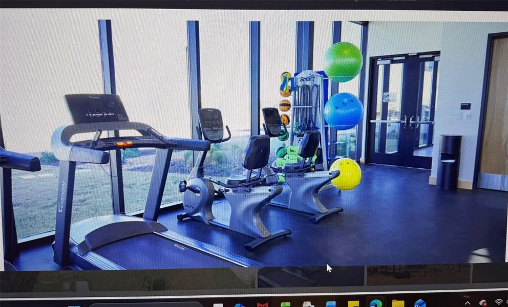 Fitness center with ample natural light provides an energizing space for workouts.