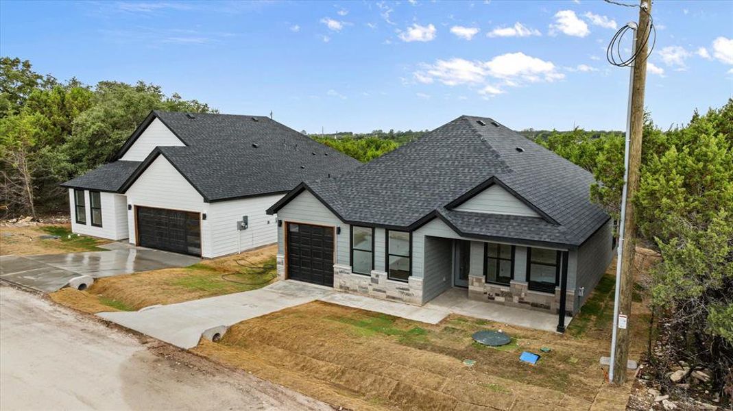 Front exterior of a new home in , Granbury, TX, highlighting curb appeal (Image 16).