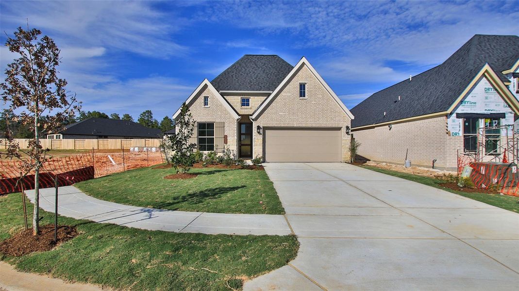 Front exterior of a new home in Audubon, Magnolia, TX, highlighting curb appeal (Image 2). Front exterior of a new home in Audubon, Magnolia, TX, highlighting curb appeal (Image 2).