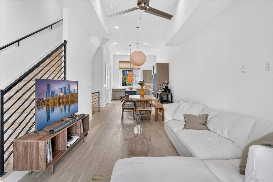 An open-concept living space with sleek flooring and a contemporary staircase.