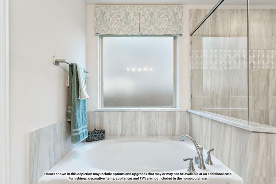 Soaking tub with tile surround, frosted window, and glass shower enclosure nearby Soaking tub with tile surround, frosted window, and glass shower enclosure nearby