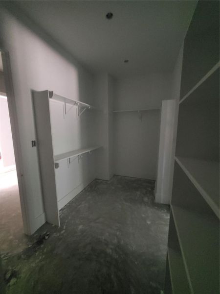 MASSIVE PRIMARY CLOSET WITH A WALK-THROUGH TO THE LAUNDRY ROOM AND THE BACK HALLWAY LEADING TO THE GARAGE FOR EASY ACCESS.