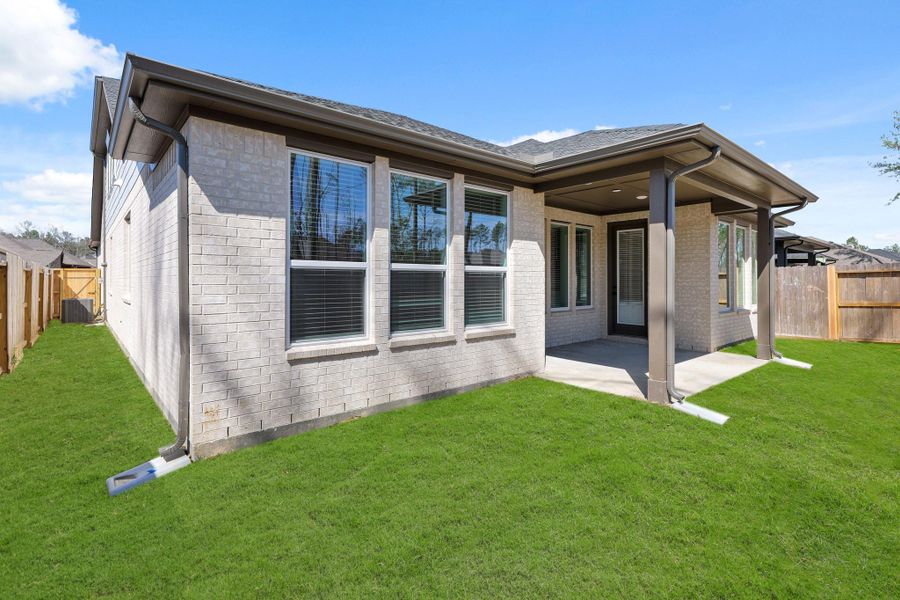 Front exterior of a new home in The Highlands 50', Porter, TX, highlighting curb appeal (Image 1).