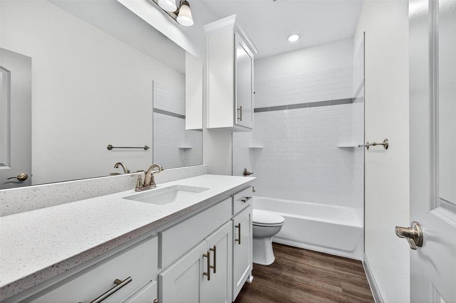 Full bath with vanity, shower / tub combination, and dark wood-style floors