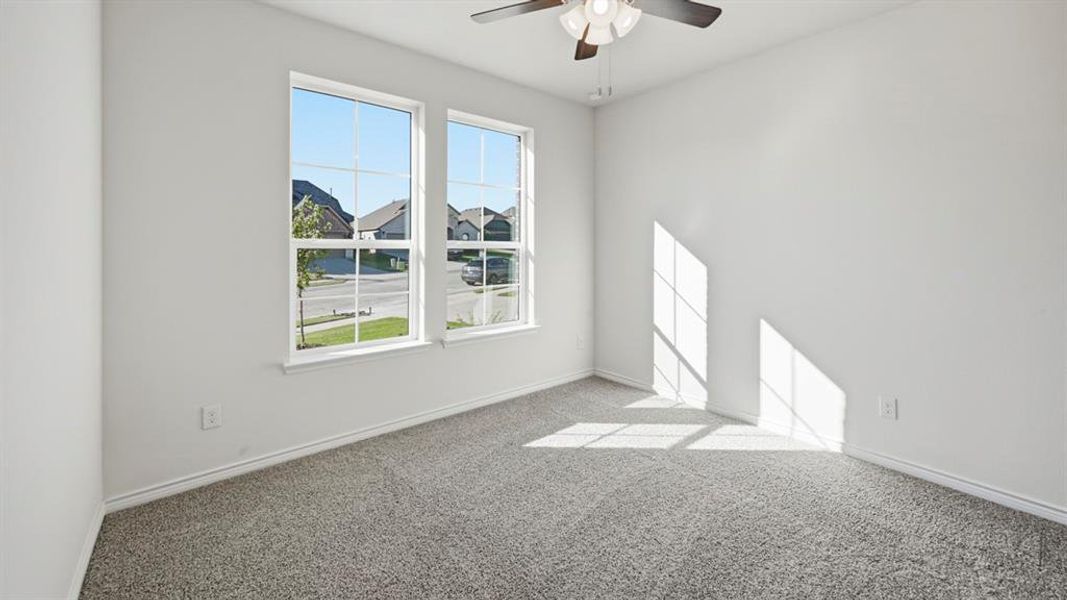 Empty room with carpet and ceiling fan