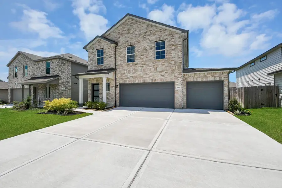 Front exterior of a new home in Hill and Dale Ranch, Splendora, TX, highlighting curb appeal (Image 2).