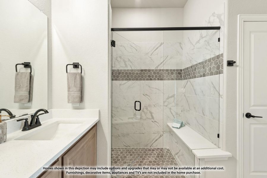 Bathroom with glass walk-in shower, marble tile walls, built-in bench, and vanity with white countertop Bathroom with glass walk-in shower, marble tile walls, built-in bench, and vanity with white countertop