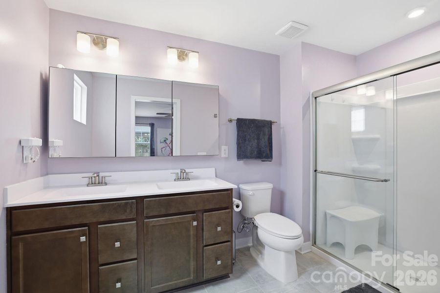 Primary bath with dual sinks and oversized, walk-in shower