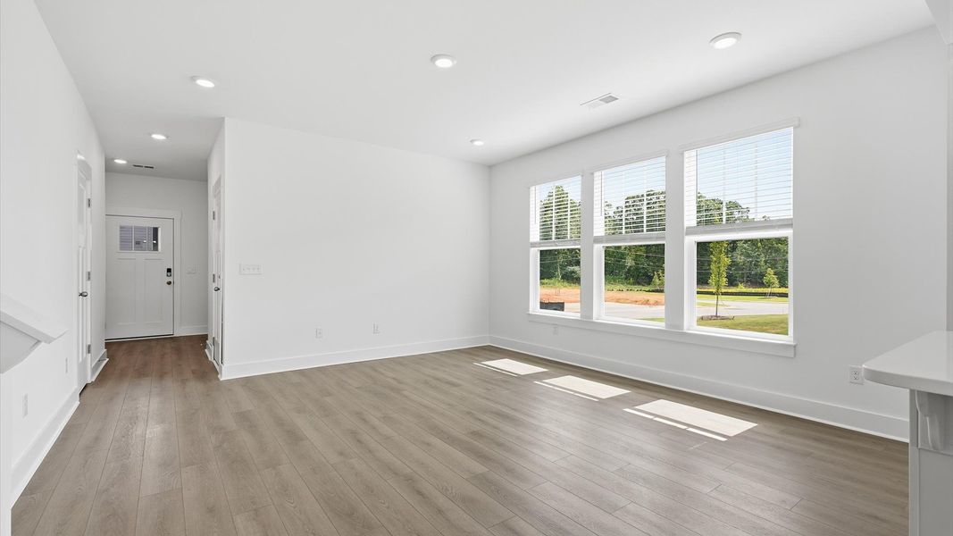 Memorable moments begin in this elegant, open family room with hardwood flooring and refined finishes