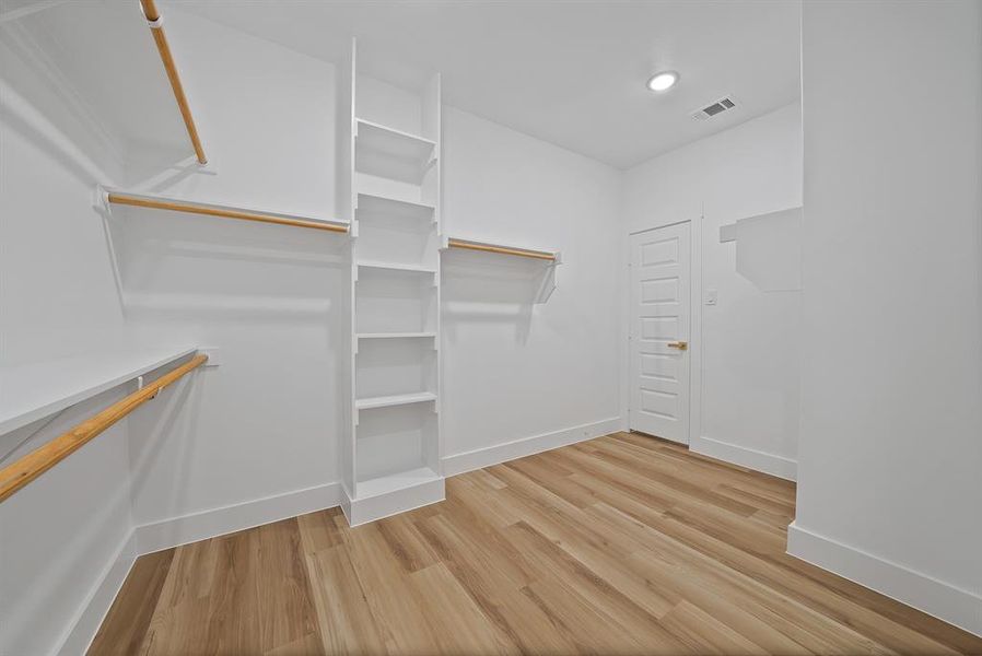 Walk in closet featuring light wood-style flooring