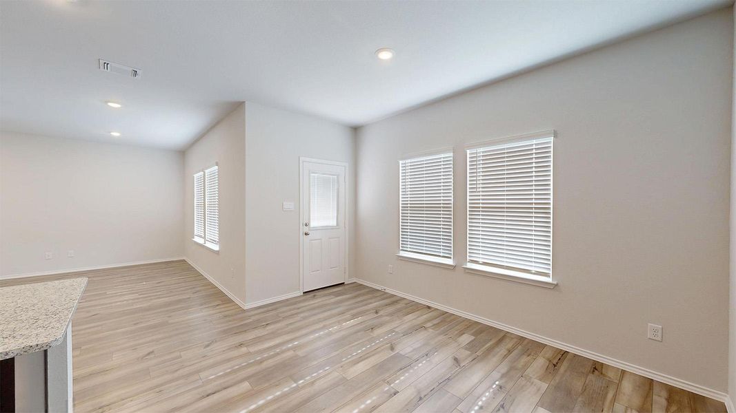 Foyer with light wood finished floors and recessed lighting