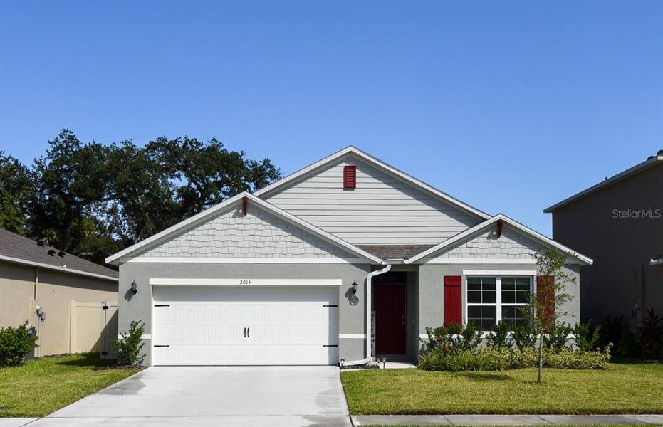 Front exterior of a new home in Oak Leaf Preserve, New Smyrna Beach, FL, highlighting curb appeal (Image 2). Front exterior of a new home in Oak Leaf Preserve, New Smyrna Beach, FL, highlighting curb appeal (Image 2).