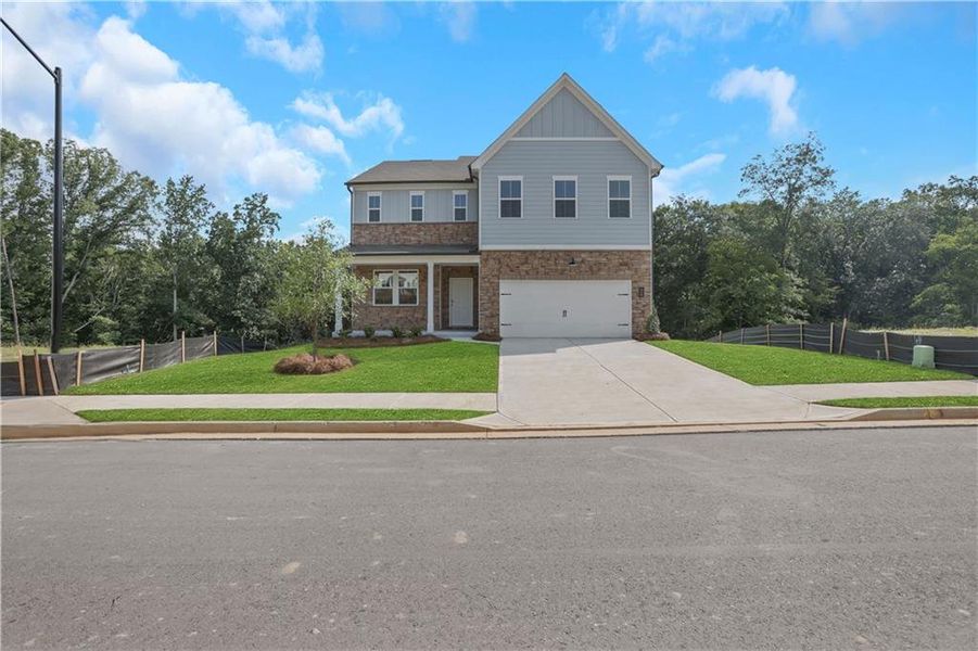Front exterior of a new home in Easton Walk, Lawrenceville, GA, highlighting curb appeal (Image 1). Front exterior of a new home in Easton Walk, Lawrenceville, GA, highlighting curb appeal (Image 1).