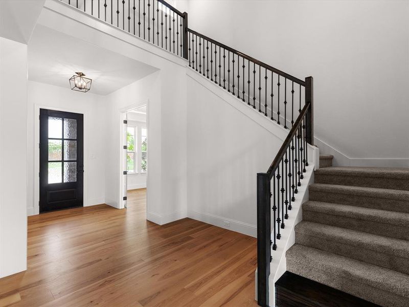Entryway with stairway and wood finished floors
