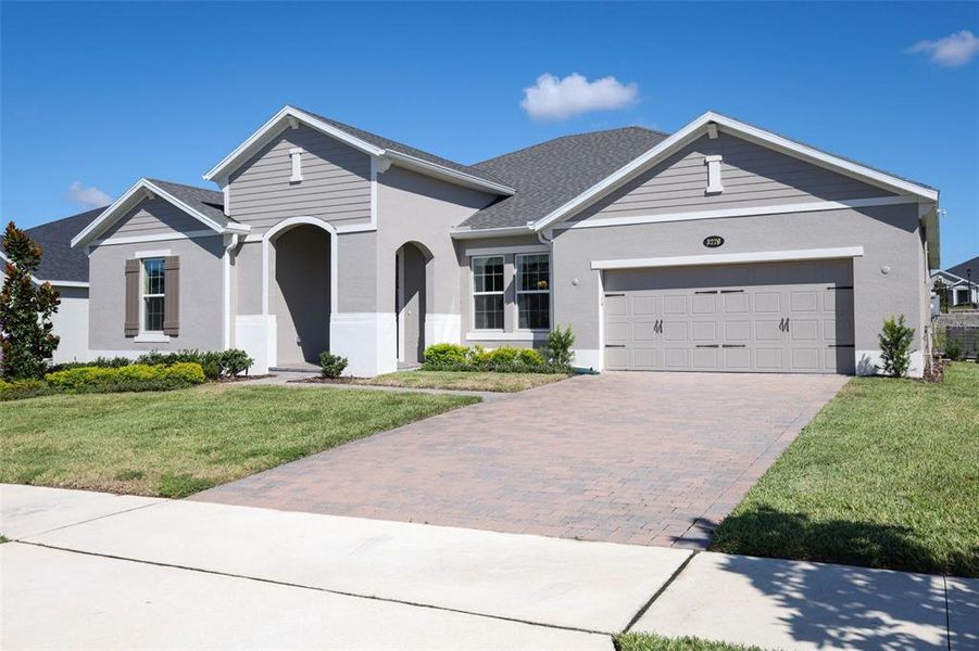 Front exterior of a new home in Wolf Lake Ranch, Apopka, FL, highlighting curb appeal (Image 2).