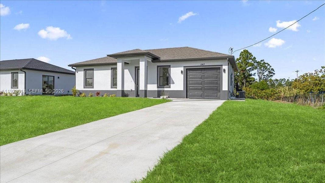 Front exterior of a new home in , Lehigh Acres, FL, highlighting curb appeal (Image 18).