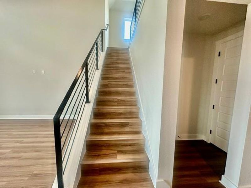 Clean lines define this home's staircase, blending modern design with timeless wood tones. Clean lines define this home's staircase, blending modern design with timeless wood tones.
