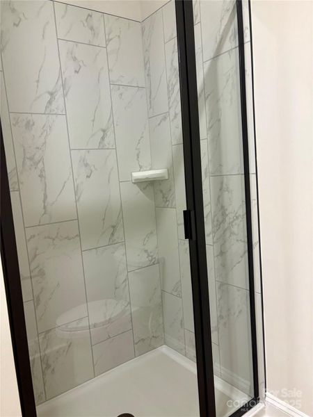 Photo Taken 11/29 Primary Bath With Tiled Shower And Black Frame