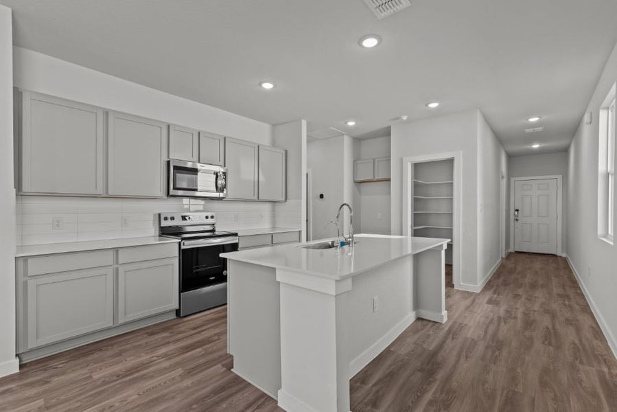 A kitchen with white cabinets.