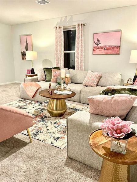 Carpeted living area with visible vents