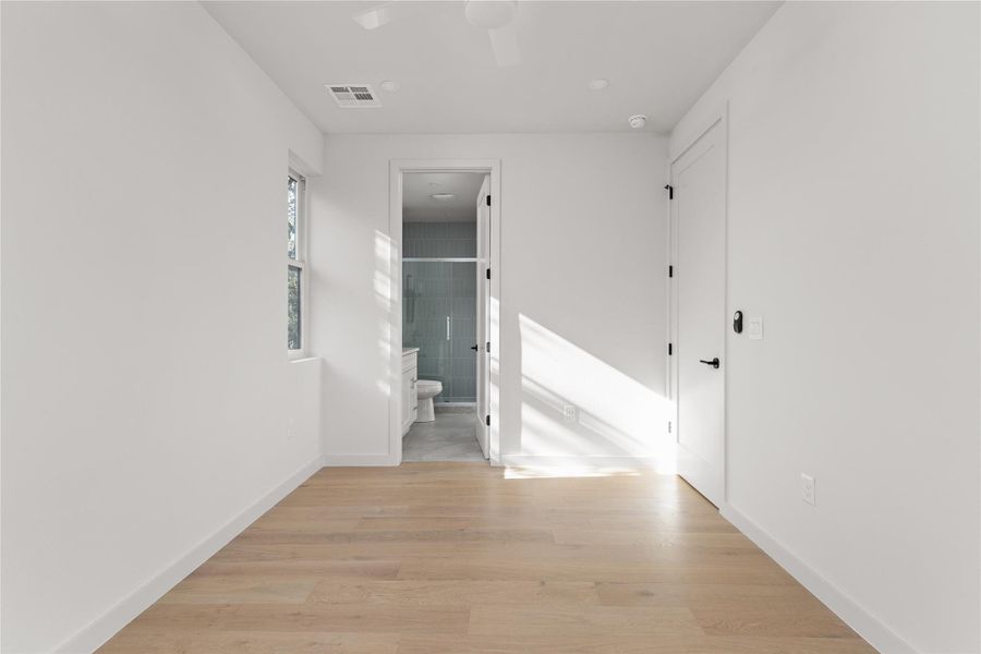 Hall with light wood-type flooring and baseboards