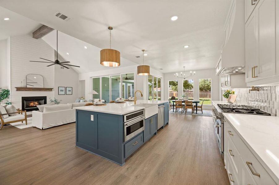 Kitchen with white cabinets, blue cabinetry, light wood-style flooring, recessed lighting, and beamed ceiling Kitchen with white cabinets, blue cabinetry, light wood-style flooring, recessed lighting, and beamed ceiling