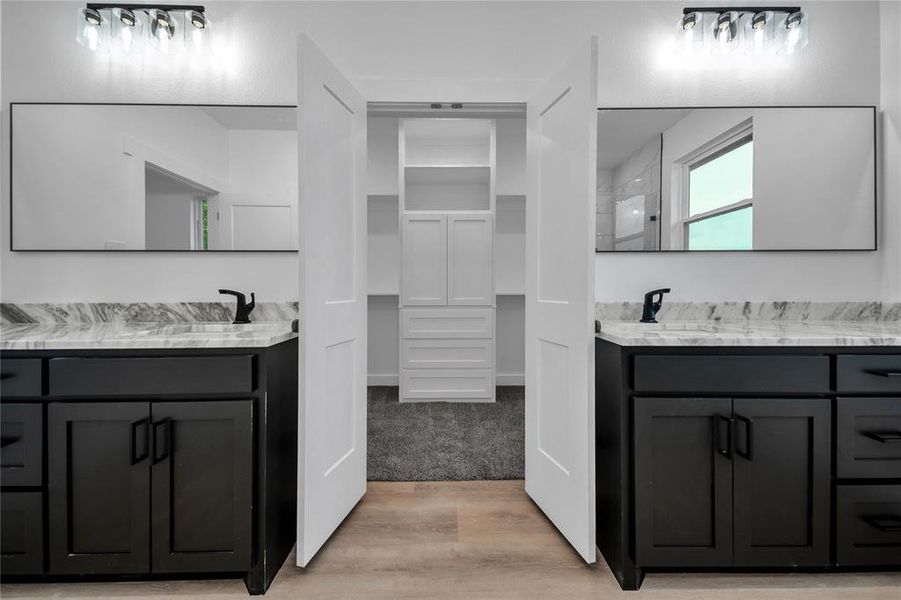 Bathroom featuring vanity and wood-type flooring