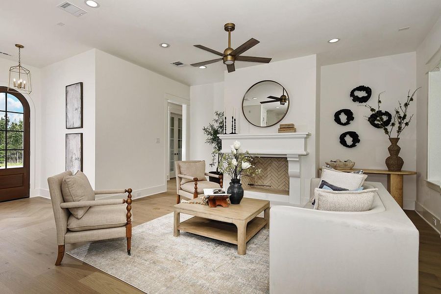 Inviting living room has a custom statement fireplace, adding depth to space and anchoring this room well.