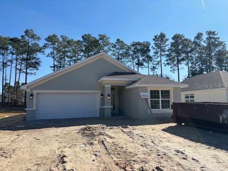 Front exterior of a new home in Juliette Falls, Dunnellon, FL, highlighting curb appeal (Image 2). Front exterior of a new home in Juliette Falls, Dunnellon, FL, highlighting curb appeal (Image 2).