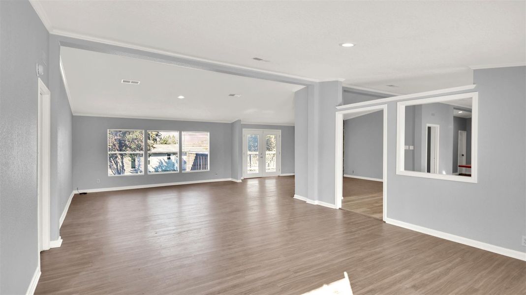 Unfurnished room with light wood-style flooring, french doors, recessed lighting, and ornamental molding
