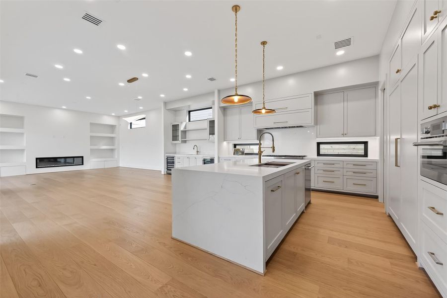 Great flow with this open-concept functional floor plan. The dining room features a modern chandelier and abundant natural light.