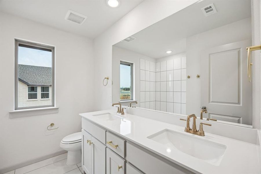 With vanity space for two, friends and family will feel right at home in this thoughtfully designed guest bath.