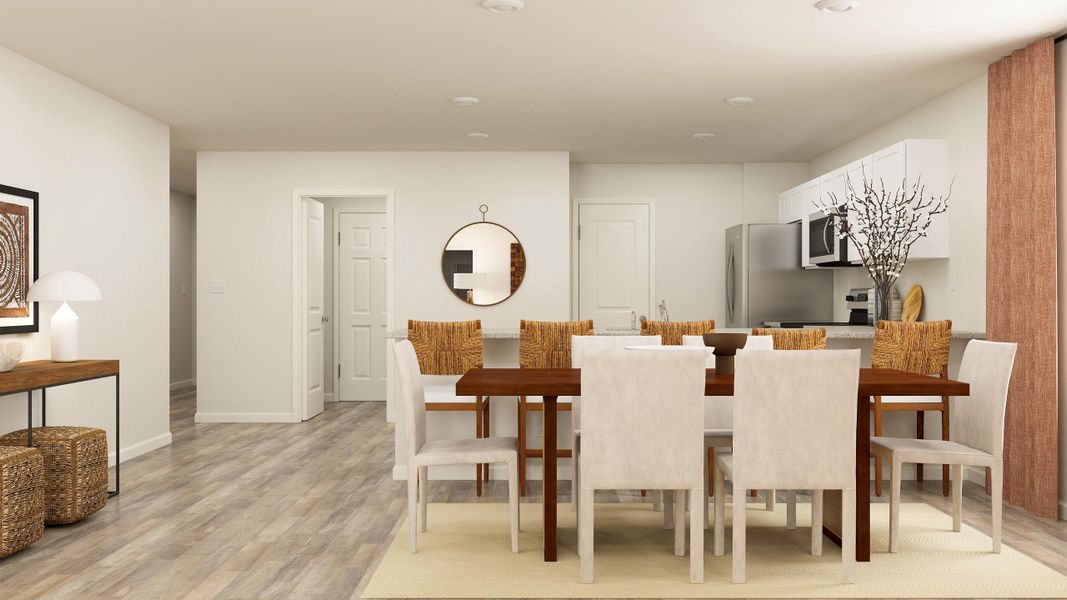 A dining room with a table and chairs.