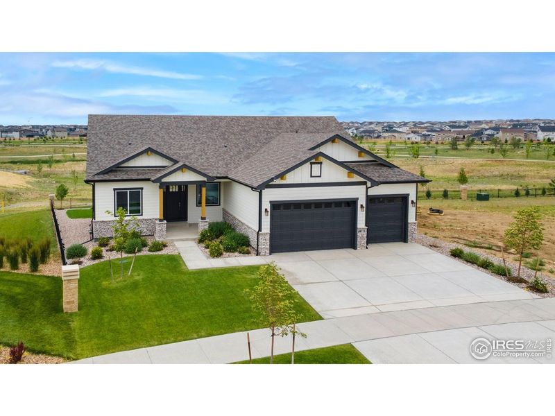 Front exterior of a new home in Aurora Highlands, Aurora, CO, highlighting curb appeal (Image 23). Front exterior of a new home in Aurora Highlands, Aurora, CO, highlighting curb appeal (Image 23).
