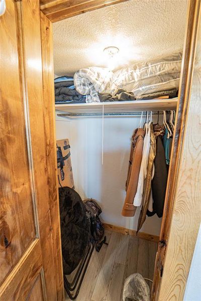 Walk in closet featuring light wood-style flooring Walk in closet featuring light wood-style flooring
