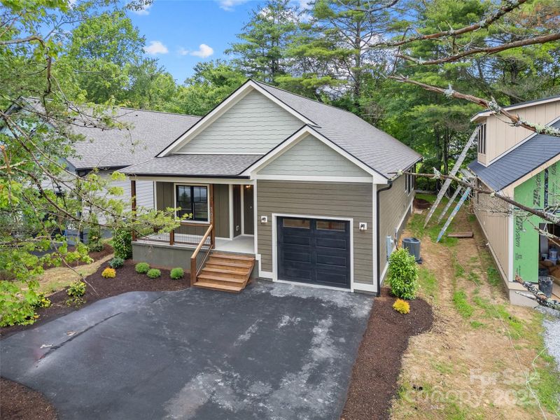 Front exterior of a new home in , Brevard, NC, highlighting curb appeal (Image 1).