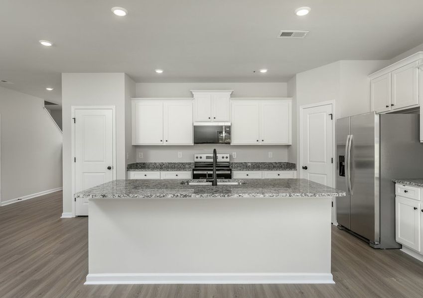 The kitchen has designer wood cabinetry
