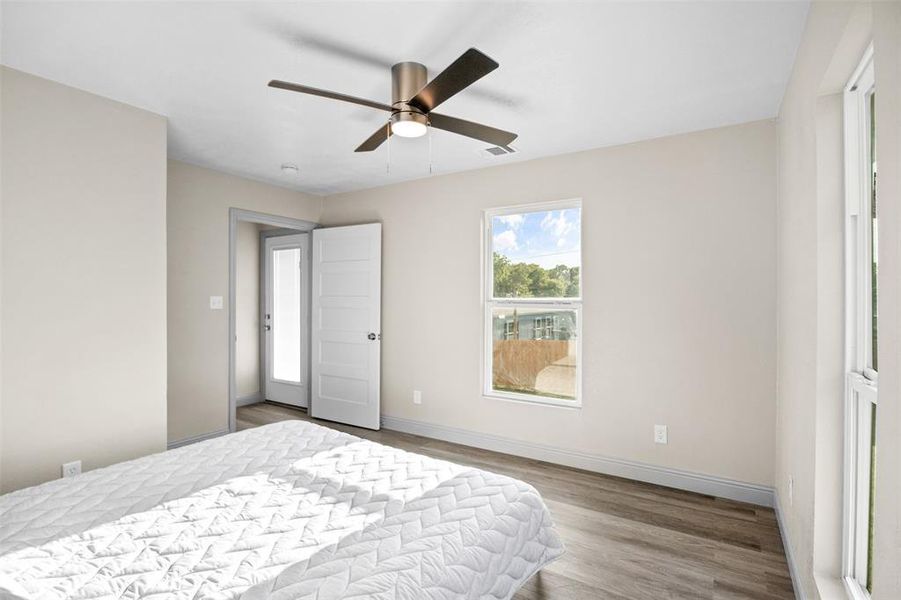 Bedroom featuring wood finished floors and a ceiling fan