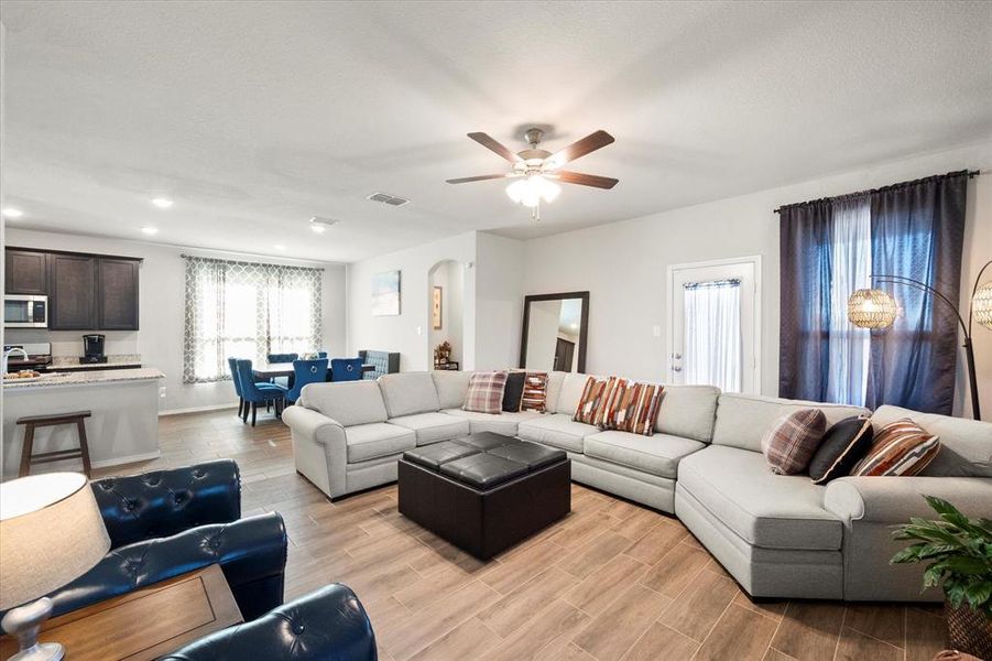 Living room featuring ceiling fan and light hardwood / wood-style flooring