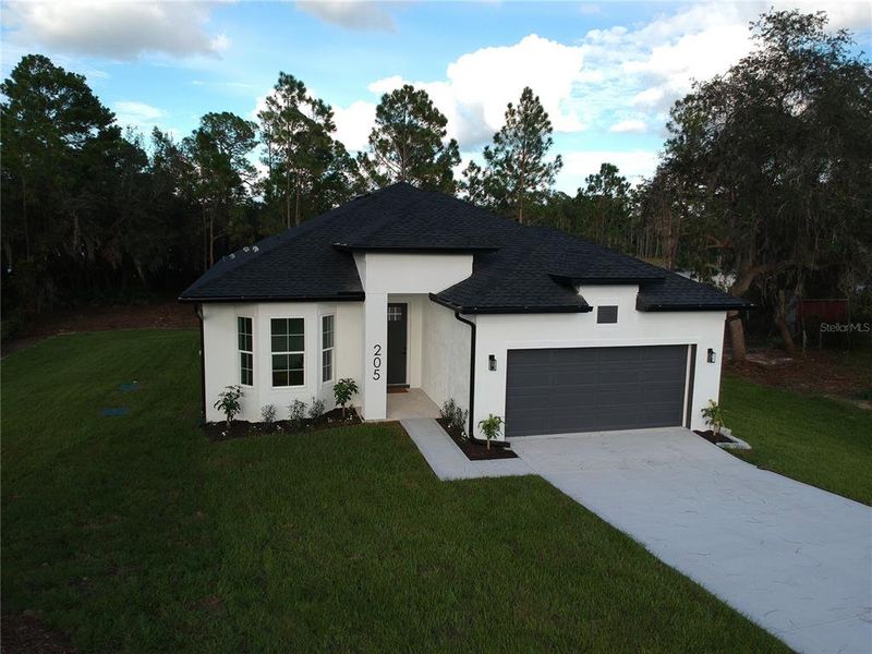 Front exterior of a new home in , Deltona, FL, highlighting curb appeal (Image 29). Front exterior of a new home in , Deltona, FL, highlighting curb appeal (Image 29).