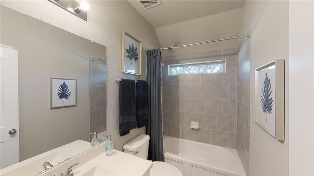 Full bath featuring shower / tub combo and vanity Full bath featuring shower / tub combo and vanity