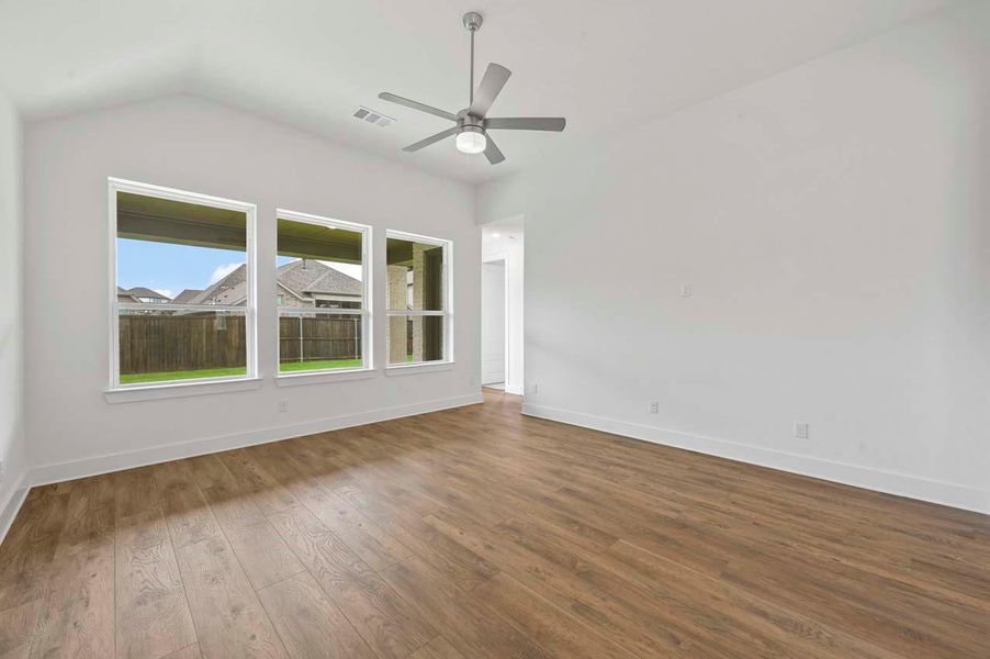 Empty room with a ceiling fan, baseboards, dark wood finished floors, and visible vents