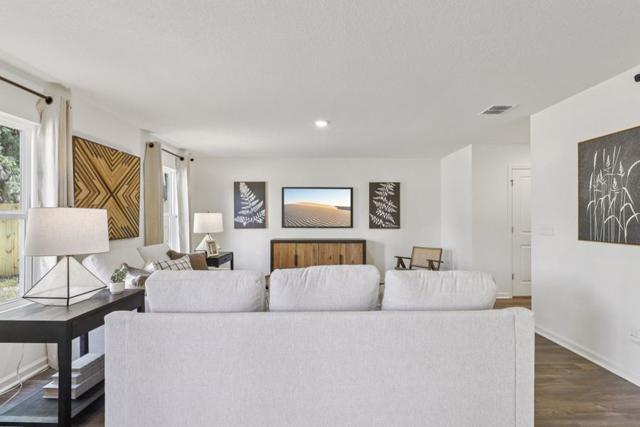 A large white living room with a large white couch. A large white living room with a large white couch.